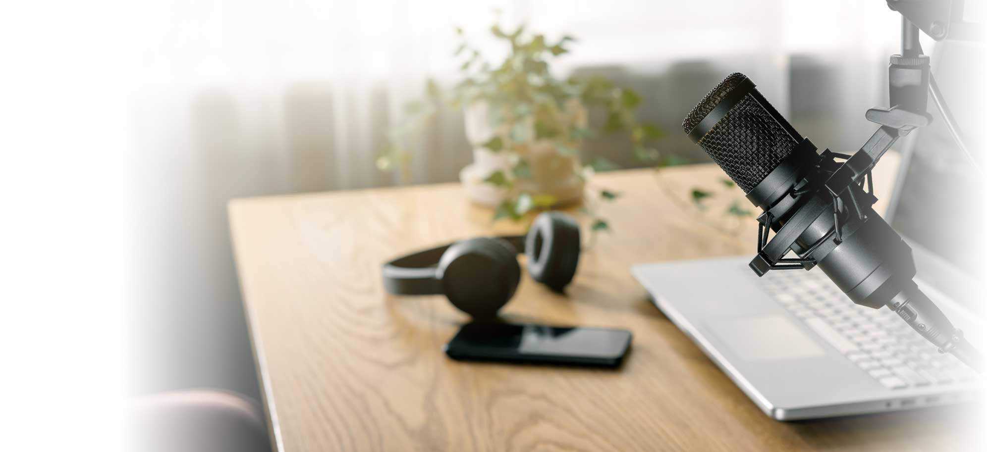 Workplace of content creator with microphone, laptop and headphones. home studio for podcasting